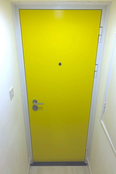 Bright yellow security doors installed in Greenwich.