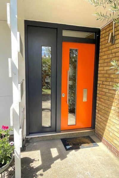 Beautiful security door with a side panel in orange.