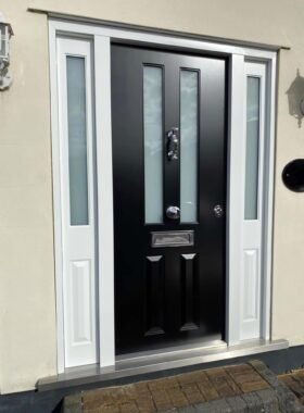 Security entry door with glazed side panels installed in Greater London.